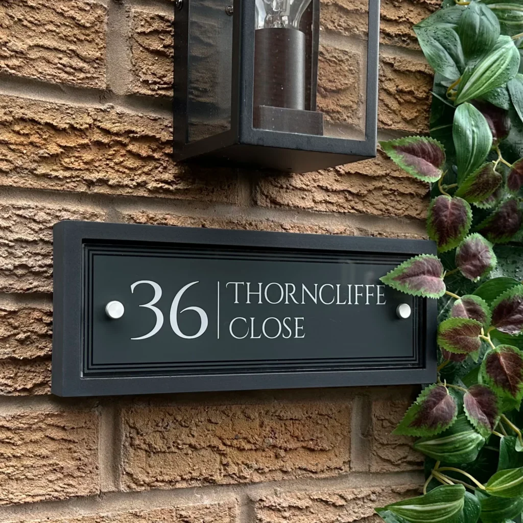 Premium reflective Welsh slate house sign on a warm stone frontage